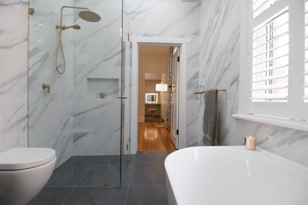 Design ideas for a mid-sized contemporary master bathroom in Adelaide with shaker cabinets, black cabinets, a freestanding tub, a corner shower, a wall-mount toilet, black and white tile, porcelain tile, white walls, porcelain floors, engineered quartz benchtops, grey floor, a hinged shower door, white benchtops, a double vanity and a floating vanity.