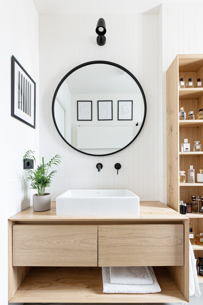 Small scandinavian 3/4 bathroom in Milan with flat-panel cabinets, light wood cabinets, white tile, white walls, a vessel sink, wood benchtops, a single vanity, a floating vanity and beige benchtops.