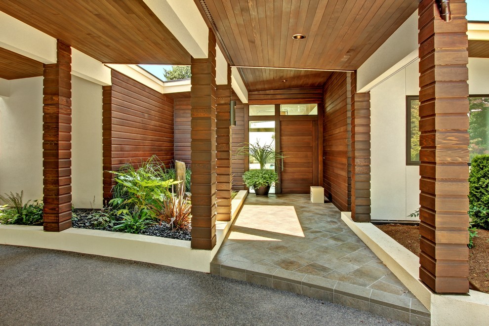 This is an example of a contemporary front door in Seattle with a single front door and a medium wood front door.