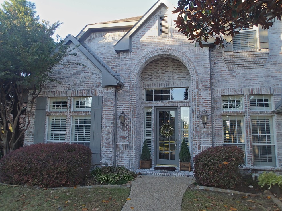 Design ideas for a large traditional two-storey brick white exterior in Dallas with a gable roof.