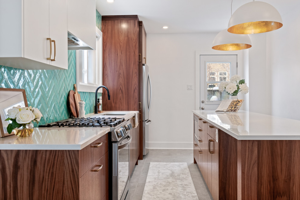 This is an example of a small midcentury single-wall separate kitchen in Ottawa with an undermount sink, flat-panel cabinets, medium wood cabinets, quartz benchtops, blue splashback, subway tile splashback, stainless steel appliances, porcelain floors, with island, grey floor and white benchtop.