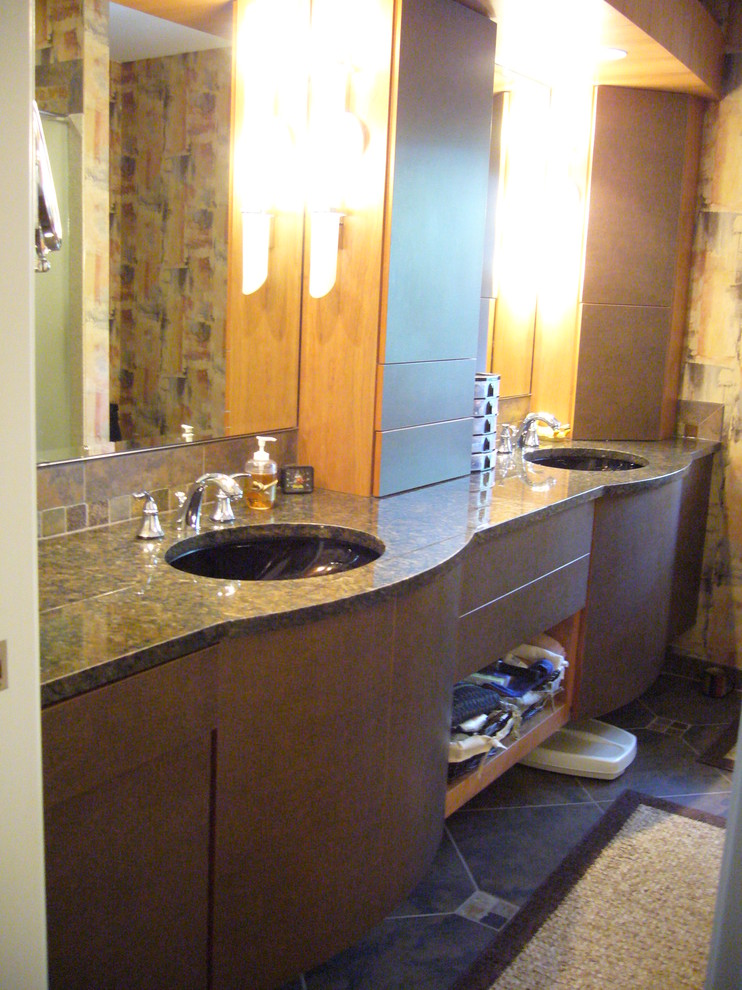 Inspiration for a mid-sized eclectic 3/4 bathroom in Milwaukee with open cabinets, dark wood cabinets, an alcove tub, a shower/bathtub combo, a two-piece toilet, ceramic tile, blue walls, mosaic tile floors, a vessel sink and glass benchtops.