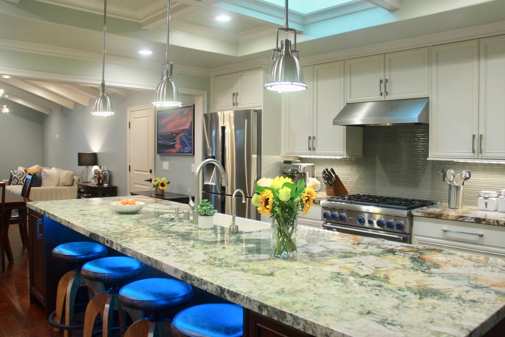 Mid-sized transitional u-shaped dark wood floor and brown floor eat-in kitchen photo in San Francisco with a farmhouse sink, recessed-panel cabinets, white cabinets, granite countertops, green backsplash, glass tile backsplash, stainless steel appliances, an island and multicolored countertops