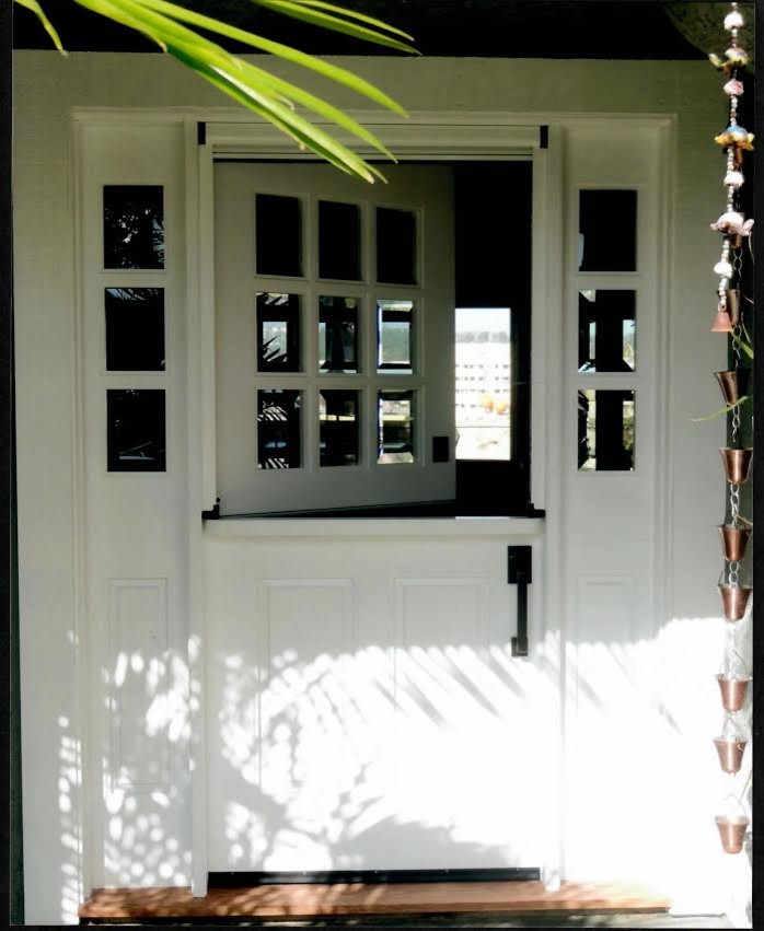 Photo of a mid-sized transitional front door in Orange County with a dutch front door, a medium wood front door and white walls.