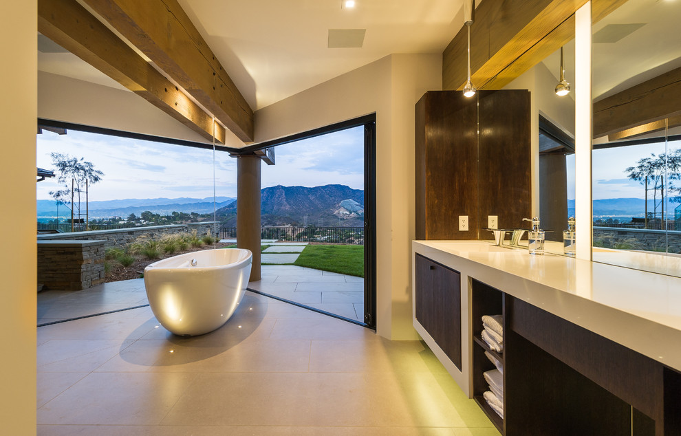 Contemporary bathroom in Los Angeles with dark wood cabinets and a freestanding tub.
