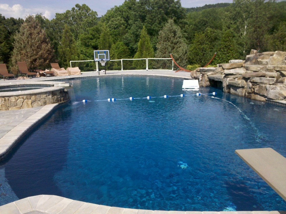Pool fountain - mid-sized backyard concrete paver and custom-shaped pool fountain idea in DC Metro