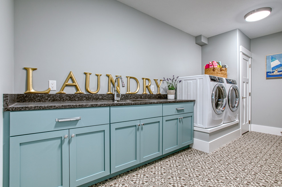 Design ideas for a large traditional single-wall dedicated laundry room in Other with an undermount sink, shaker cabinets, blue cabinets, grey walls, a side-by-side washer and dryer, grey floor and grey benchtop.