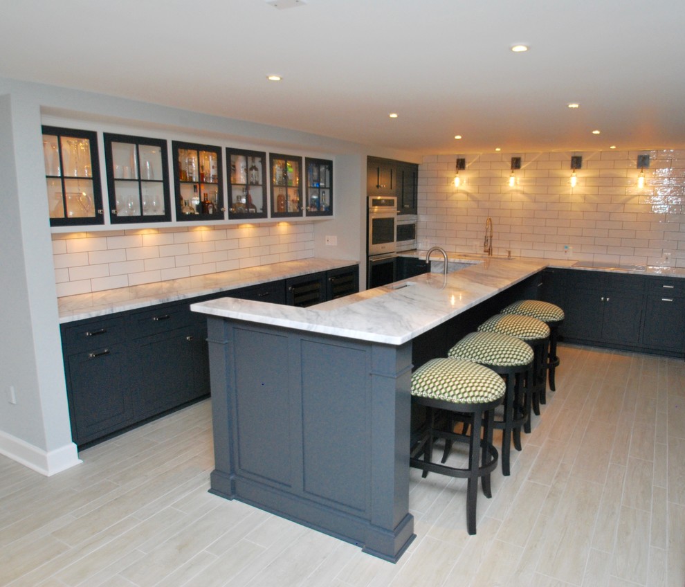 Photo of a large traditional l-shaped open plan kitchen in DC Metro with an undermount sink, beaded inset cabinets, grey cabinets, quartzite benchtops, white splashback, ceramic splashback, stainless steel appliances, ceramic floors and grey floor.