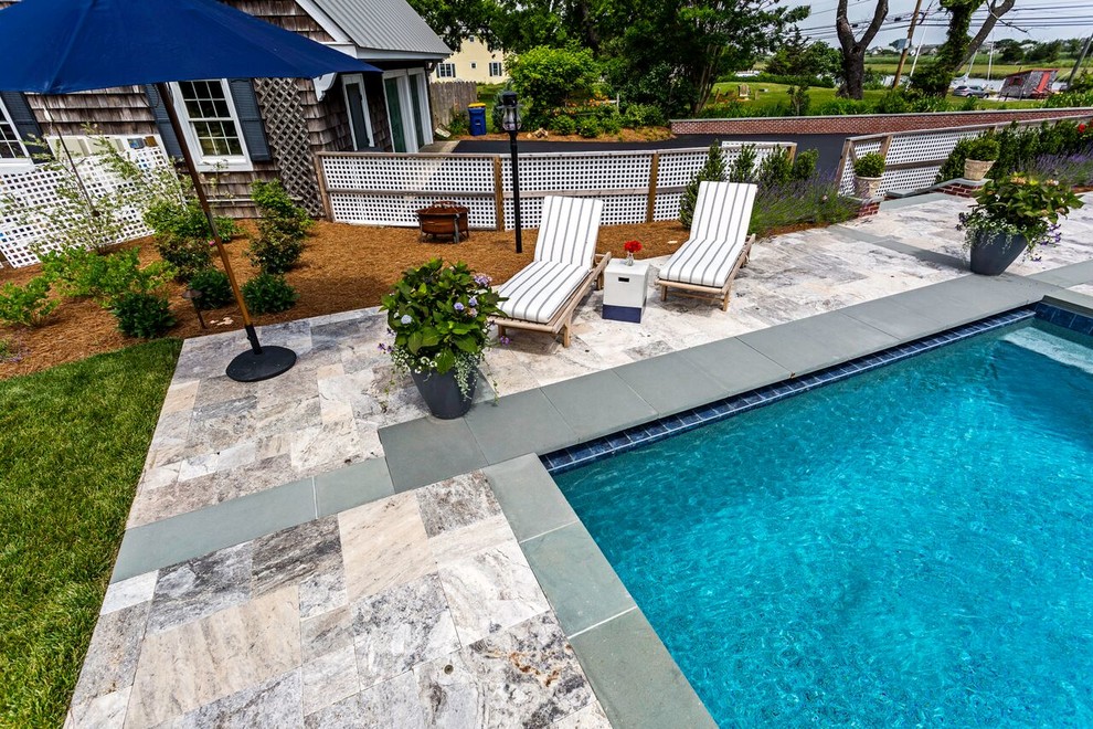 Inspiration for a large transitional backyard stone and rectangular lap hot tub remodel