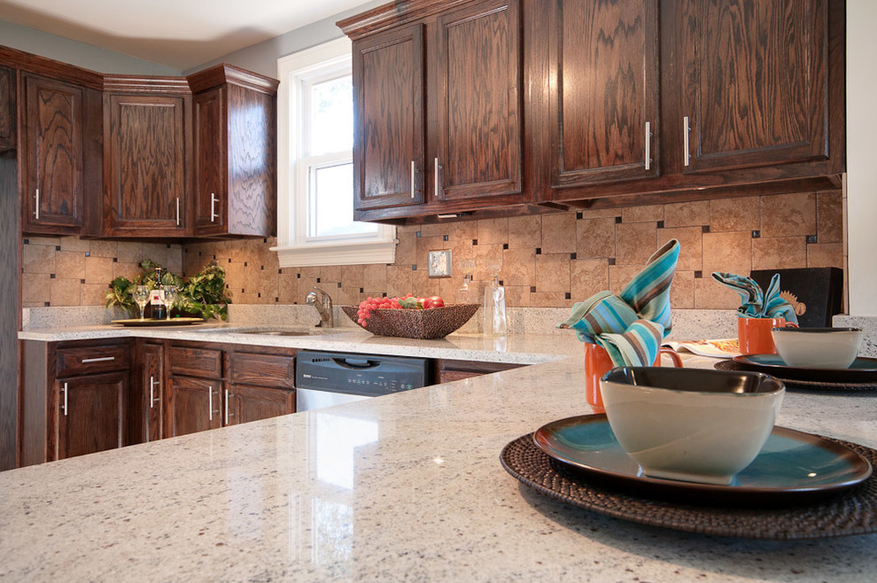 Home design - mid-sized transitional l-shaped dark wood floor home design idea in Nashville with a drop-in sink, recessed-panel cabinets, dark wood cabinets, granite countertops, brown backsplash, porcelain backsplash, stainless steel appliances and no island