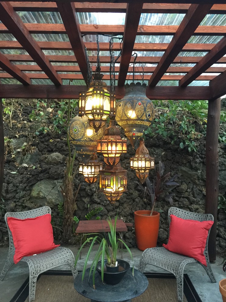 Inspiration for a mid-sized tropical backyard patio in Hawaii with concrete pavers.
