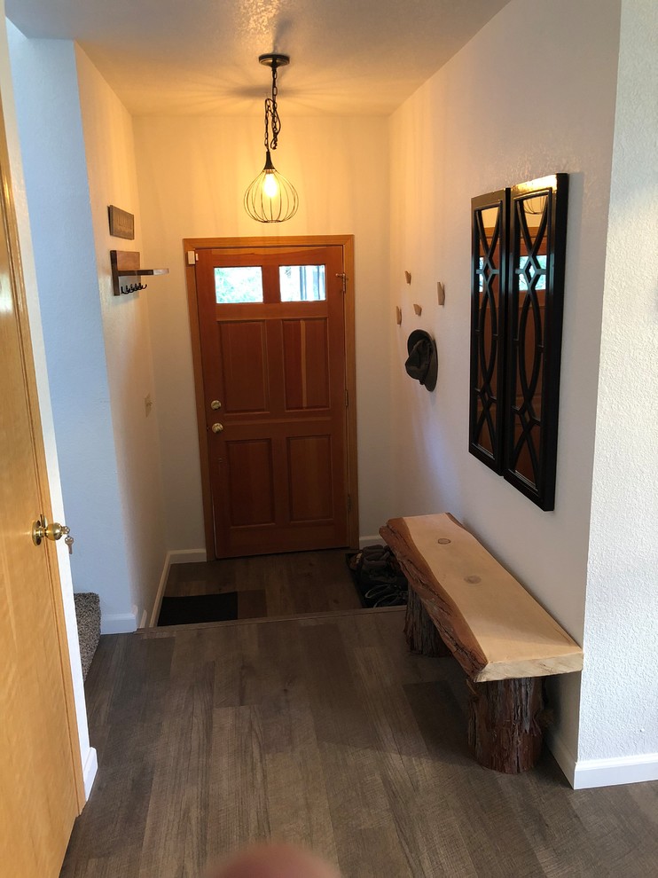 Inspiration for a mid-sized rustic dark wood floor and brown floor front door remodel with white walls and a medium wood front door