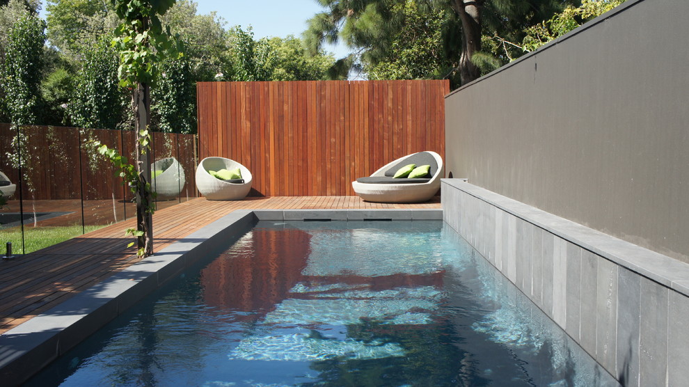 Photo of a mid-sized contemporary rectangular lap pool in Melbourne with decking.