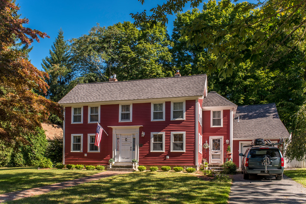 This is an example of a large traditional three-storey red house exterior in Boston with mixed siding, a gable roof and a shingle roof.
