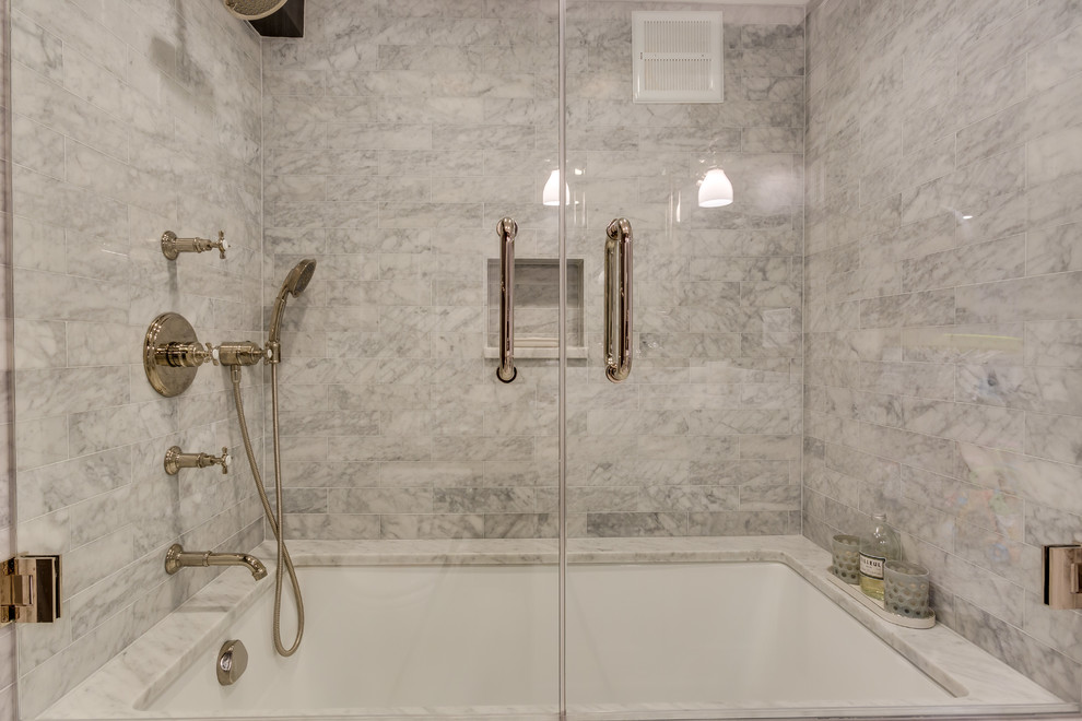 Photo of a small transitional bathroom in Chicago with recessed-panel cabinets, white cabinets, multi-coloured tile, stone slab, grey walls, marble floors, an undermount sink, marble benchtops, an alcove tub and a shower/bathtub combo.