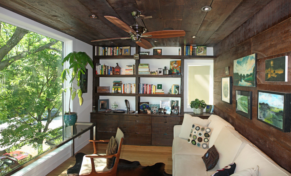 Family room - small contemporary light wood floor family room idea in Chicago with white walls