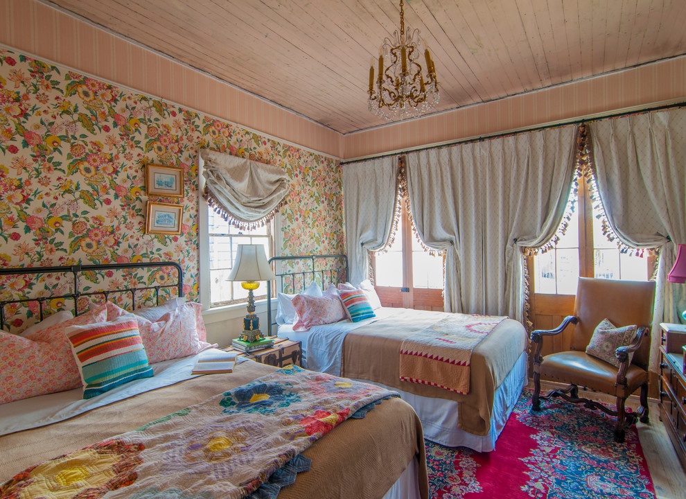 This is an example of an eclectic guest bedroom in New Orleans with multi-coloured walls and no fireplace.