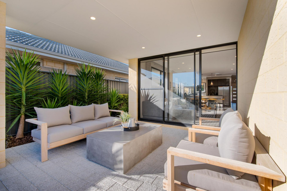 This is an example of a contemporary patio in Perth with concrete pavers and a roof extension.