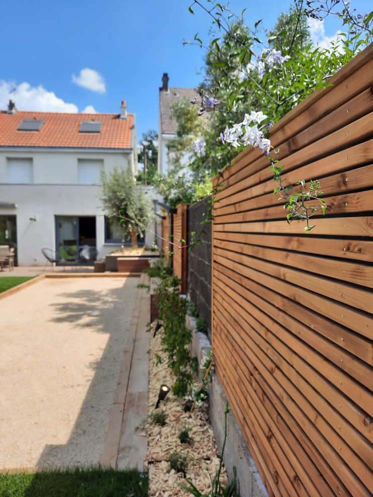 Ispirazione per un giardino design esposto in pieno sole di medie dimensioni e dietro casa in primavera con pedane e recinzione in legno