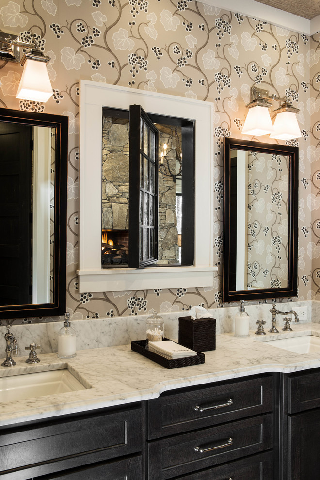 This is an example of a large transitional bathroom in Atlanta with a drop-in sink, recessed-panel cabinets, black cabinets, marble benchtops, a one-piece toilet, brown tile, stone tile, beige walls, travertine floors and with a sauna.