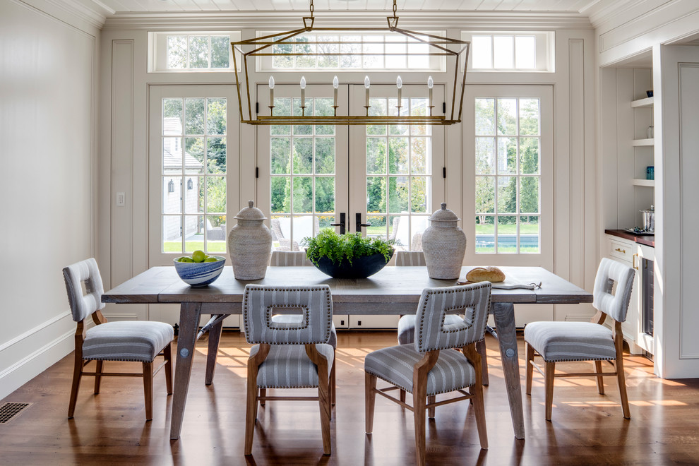 Photo of a beach style separate dining room in Boston with white walls and medium hardwood floors.