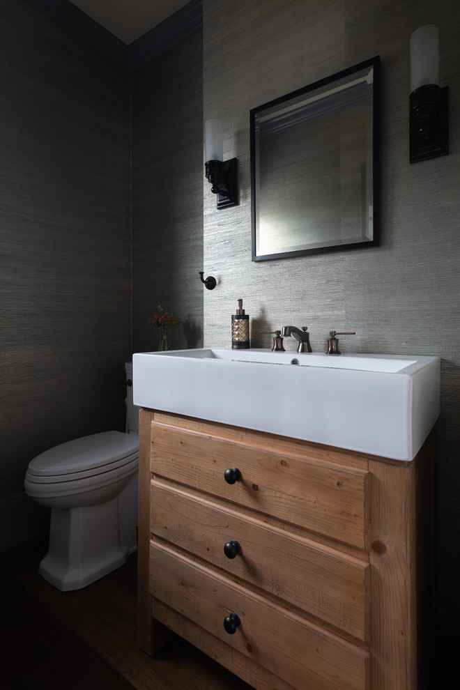 Design ideas for a small transitional bathroom in Boston with furniture-like cabinets, medium wood cabinets, a two-piece toilet, grey walls, medium hardwood floors, a vessel sink, brown floor and white benchtops.