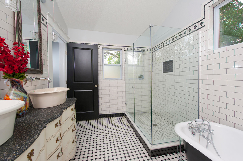 This is an example of a mid-sized arts and crafts master bathroom in Tampa with furniture-like cabinets, light wood cabinets, a claw-foot tub, a corner shower, a two-piece toilet, white tile, ceramic tile, grey walls, ceramic floors, a vessel sink, wood benchtops and multi-coloured floor.