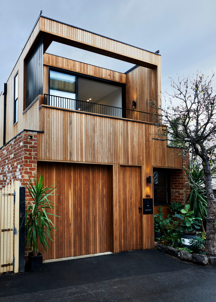 This is an example of a large contemporary two-storey multi-coloured exterior in Melbourne with mixed siding and a flat roof.