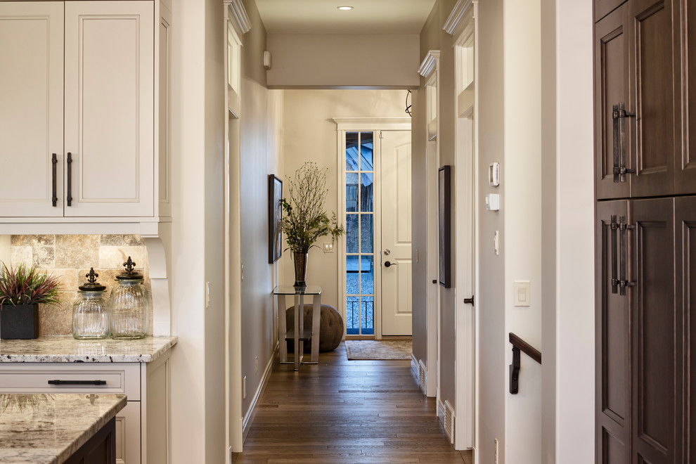 Example of a transitional medium tone wood floor foyer design in Calgary with a white front door and beige walls