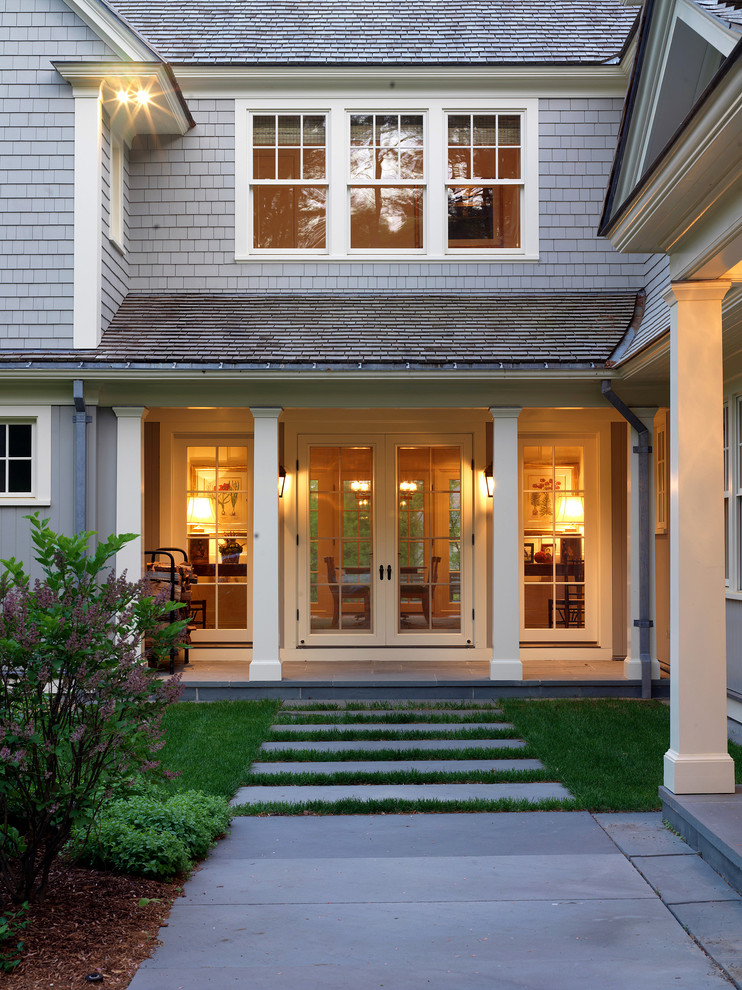 Inspiration for a large traditional two-storey grey exterior in Boston with wood siding and a hip roof.