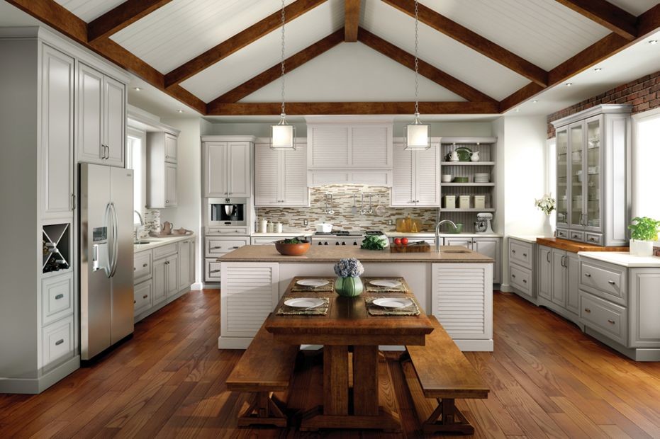 Inspiration for a mid-sized modern galley eat-in kitchen in New Orleans with a drop-in sink, raised-panel cabinets, white cabinets, granite benchtops, multi-coloured splashback, matchstick tile splashback, stainless steel appliances, medium hardwood floors and with island.