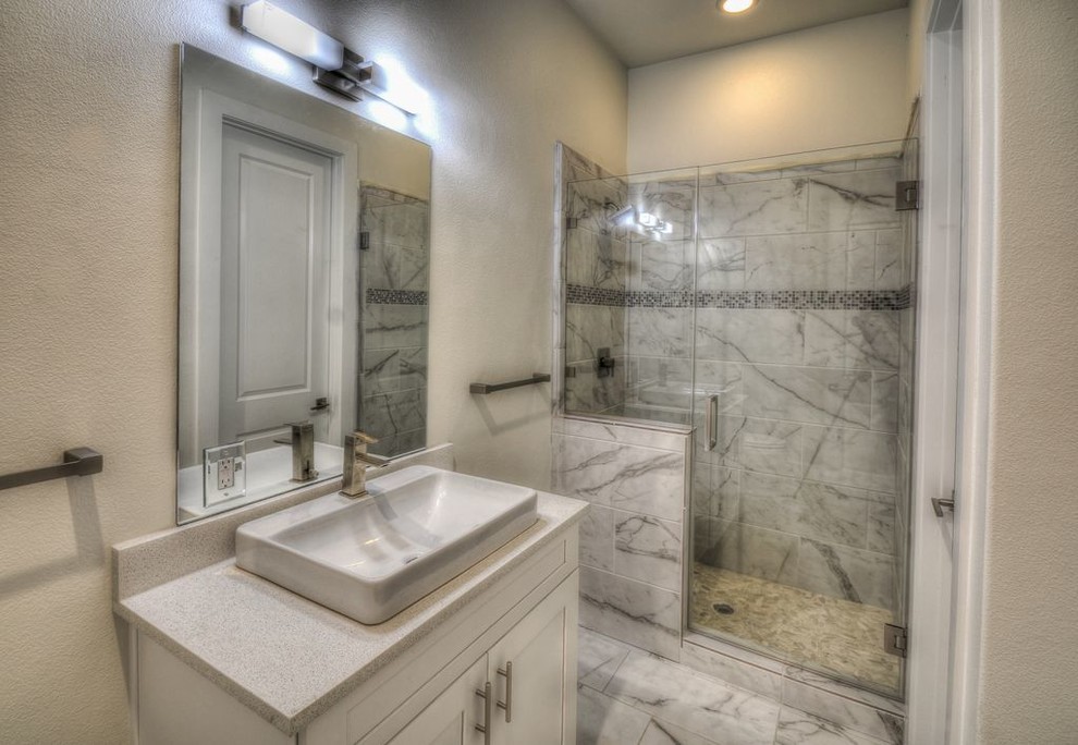 Mid-sized contemporary master bathroom in Austin with shaker cabinets, white cabinets, gray tile, marble, grey walls, marble floors, engineered quartz benchtops, grey floor, a hinged shower door, grey benchtops, an alcove shower and a vessel sink.
