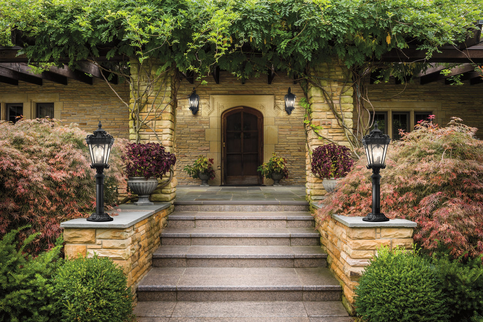 Inspiration for a large traditional front yard verandah in New York with a vertical garden and brick pavers.