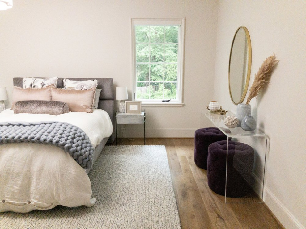This is an example of a large classic guest bedroom in Birmingham with white walls and medium hardwood flooring.