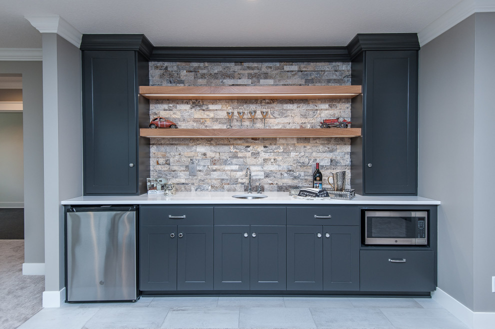 Design ideas for a transitional single-wall wet bar in Other with an undermount sink, shaker cabinets, grey cabinets, multi-coloured splashback, grey floor and white benchtop.