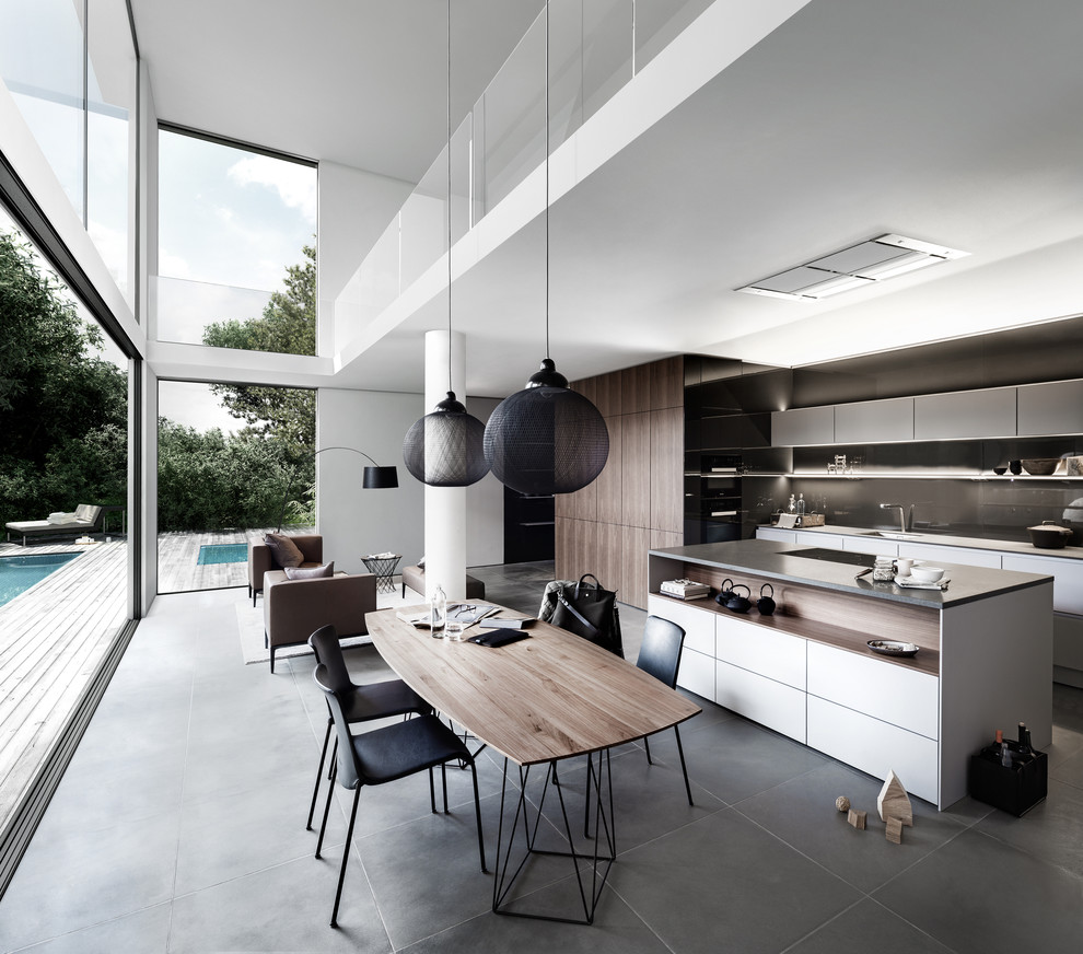 Inspiration for a large contemporary open plan dining in Hamburg with white walls, no fireplace and grey floor.