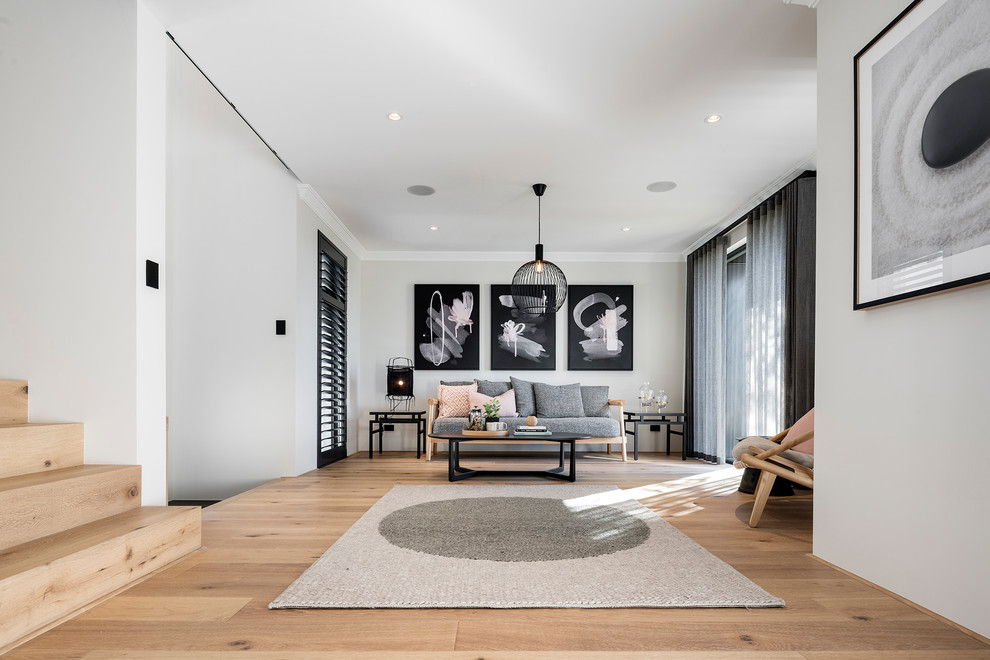 This is an example of an asian formal open concept living room in Perth with grey walls, light hardwood floors and beige floor.