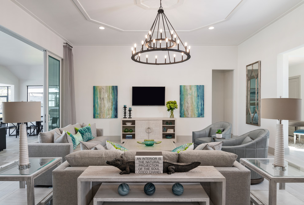 Design ideas for a mid-sized beach style open concept family room in Miami with white walls, porcelain floors, a wall-mounted tv and no fireplace.