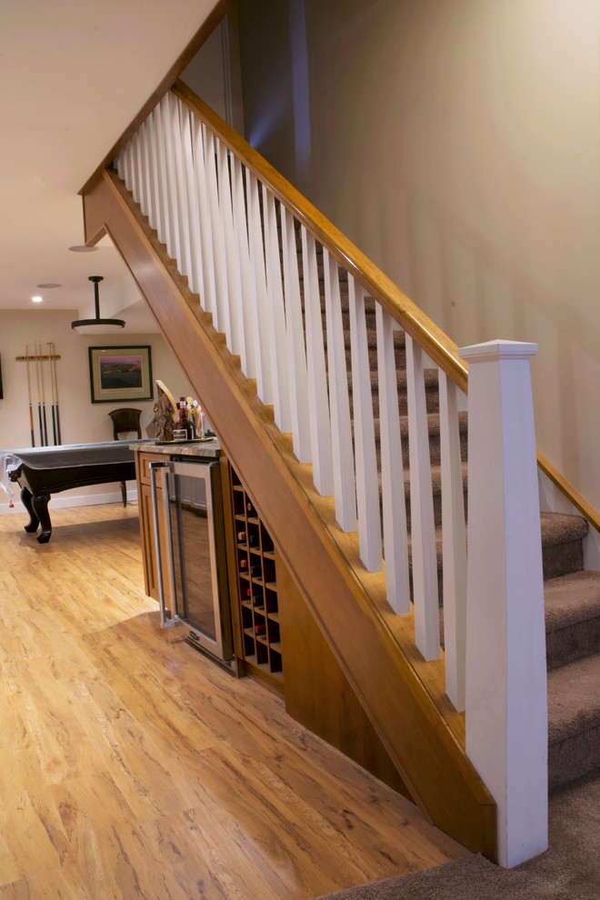 Mid-sized traditional carpeted straight staircase in Calgary with carpet risers and wood railing.
