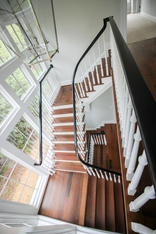 Inspiration for a large transitional wooden floating wood railing staircase remodel in DC Metro with wooden risers