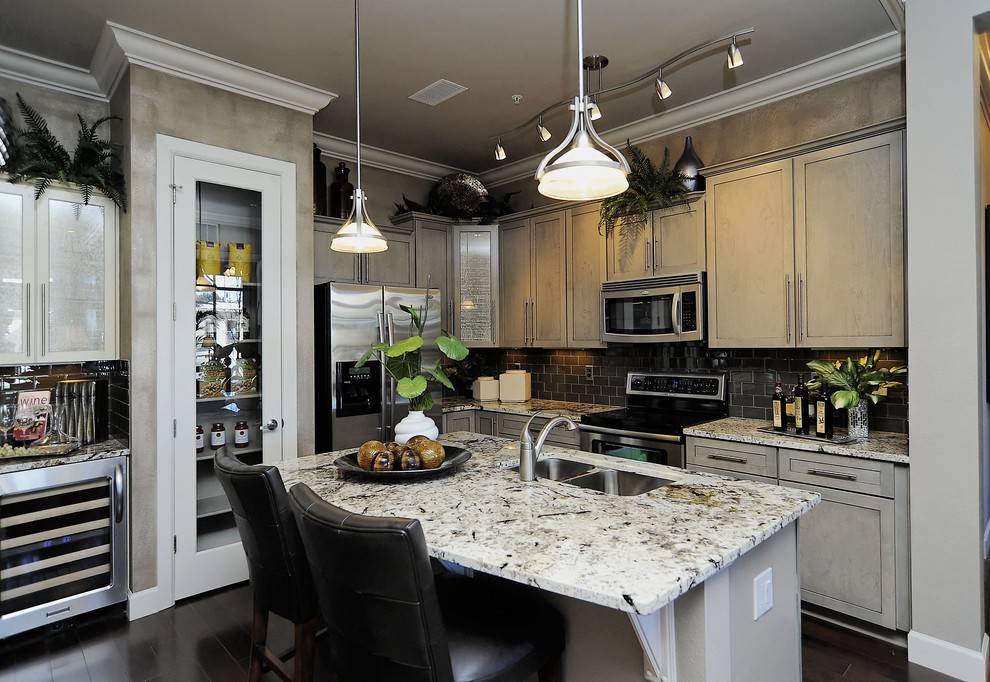 Contemporary l-shaped kitchen in Denver with grey cabinets, black splashback and subway tile splashback.