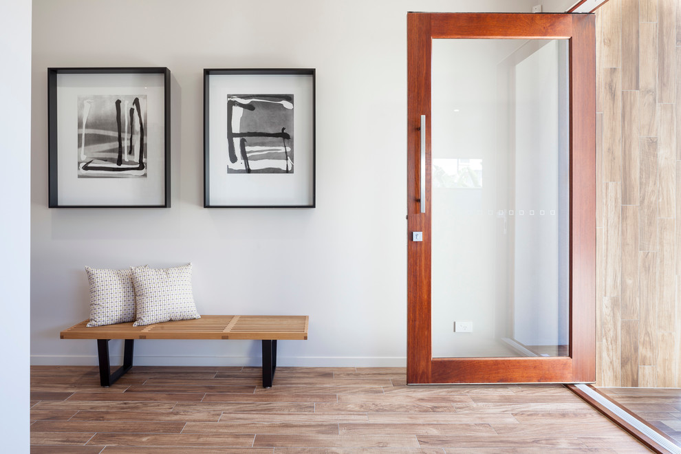 Contemporary foyer in Brisbane with white walls, light hardwood floors, a single front door and a glass front door.