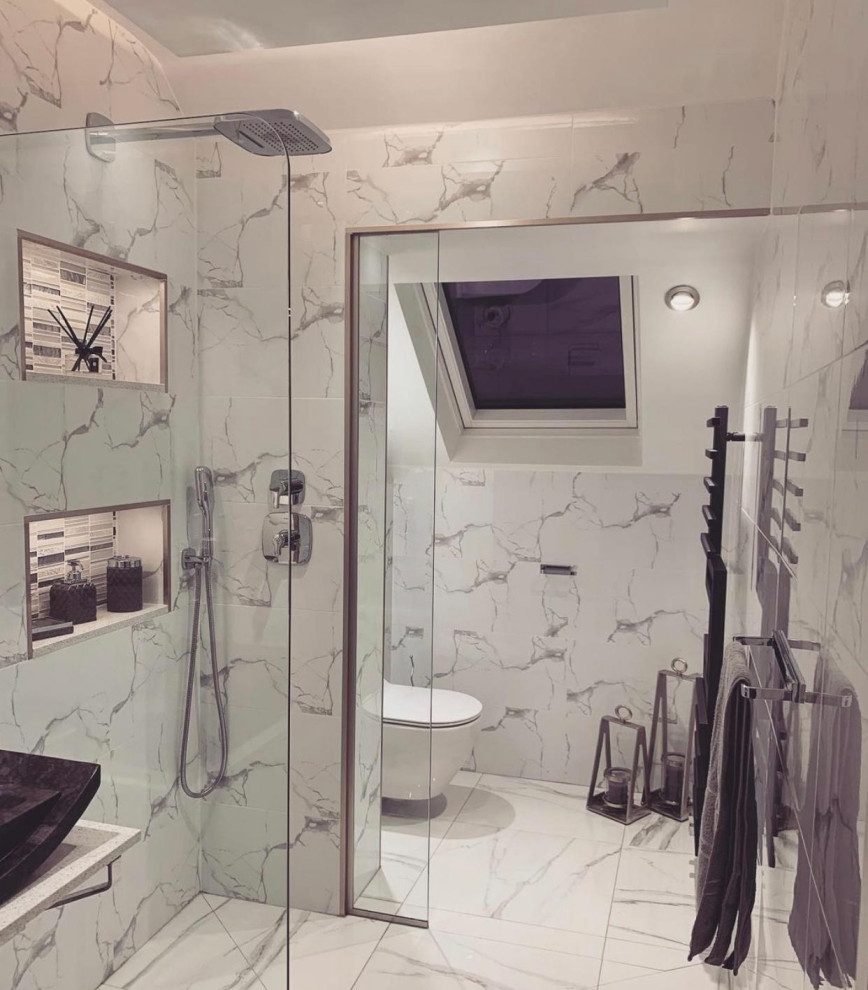 Modern inredning av ett mellanstort flerfärgad flerfärgat badrum, med möbel-liknande, vita skåp, våtrum, en vägghängd toalettstol, marmorkakel, vita väggar, marmorgolv, ett fristående handfat, marmorbänkskiva och med dusch som är öppen