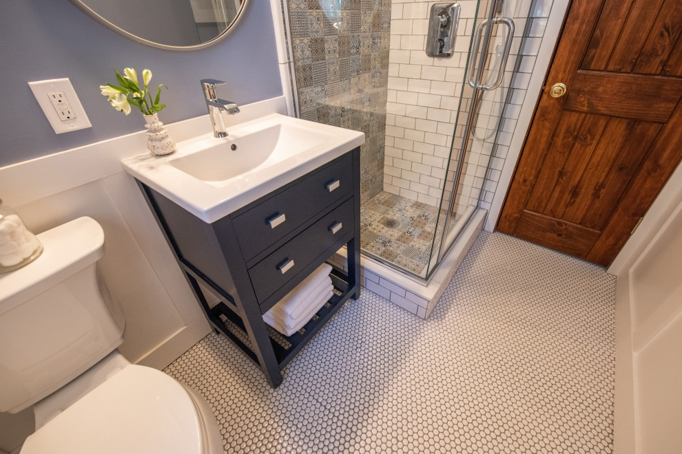 Inspiration for a small transitional powder room in Denver with open cabinets, blue cabinets, a two-piece toilet, ceramic tile, blue walls, ceramic floors, an integrated sink, white floor, white benchtops, a freestanding vanity and decorative wall panelling.