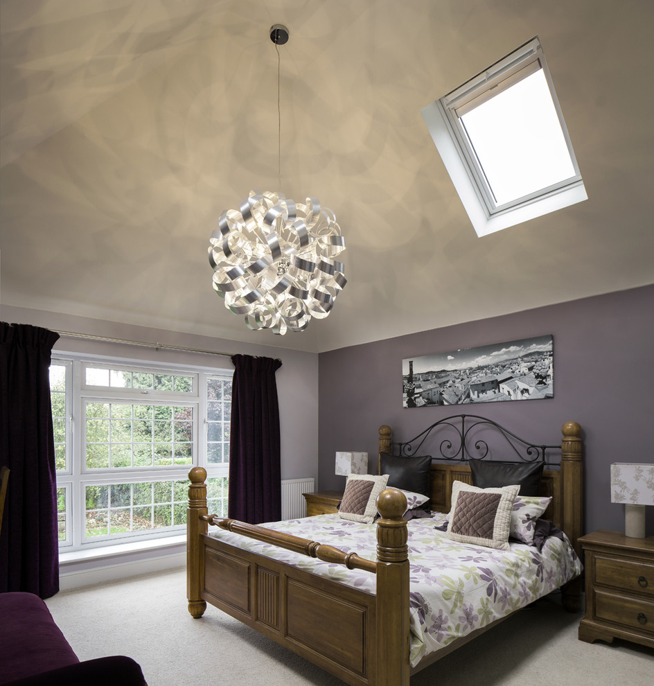 Inspiration for a traditional master bedroom in Hertfordshire with purple walls and carpet.