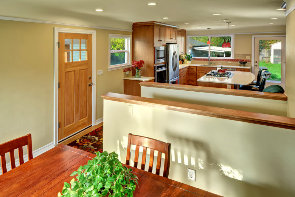 Inspiration for a small l-shaped medium tone wood floor and brown floor eat-in kitchen remodel in Seattle with an undermount sink, shaker cabinets, medium tone wood cabinets, red backsplash, mosaic tile backsplash, stainless steel appliances, an island and white countertops