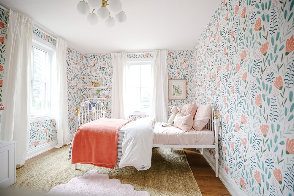 Inspiration for a mid-sized transitional girl medium tone wood floor, beige floor and wallpaper kids' room remodel in Toronto with pink walls