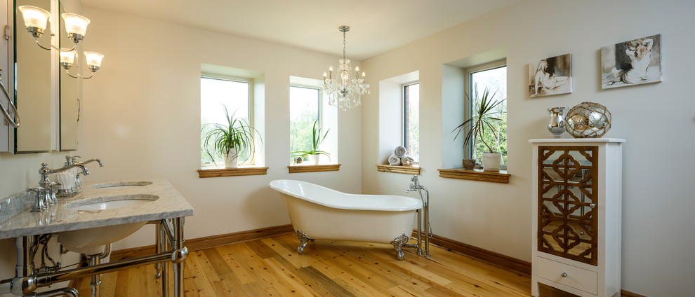 Mid-sized traditional master bathroom in Ottawa with furniture-like cabinets, white cabinets, a claw-foot tub, an alcove shower, a wall-mount toilet, white tile, glass tile, beige walls, medium hardwood floors, a console sink, granite benchtops, brown floor and a hinged shower door.