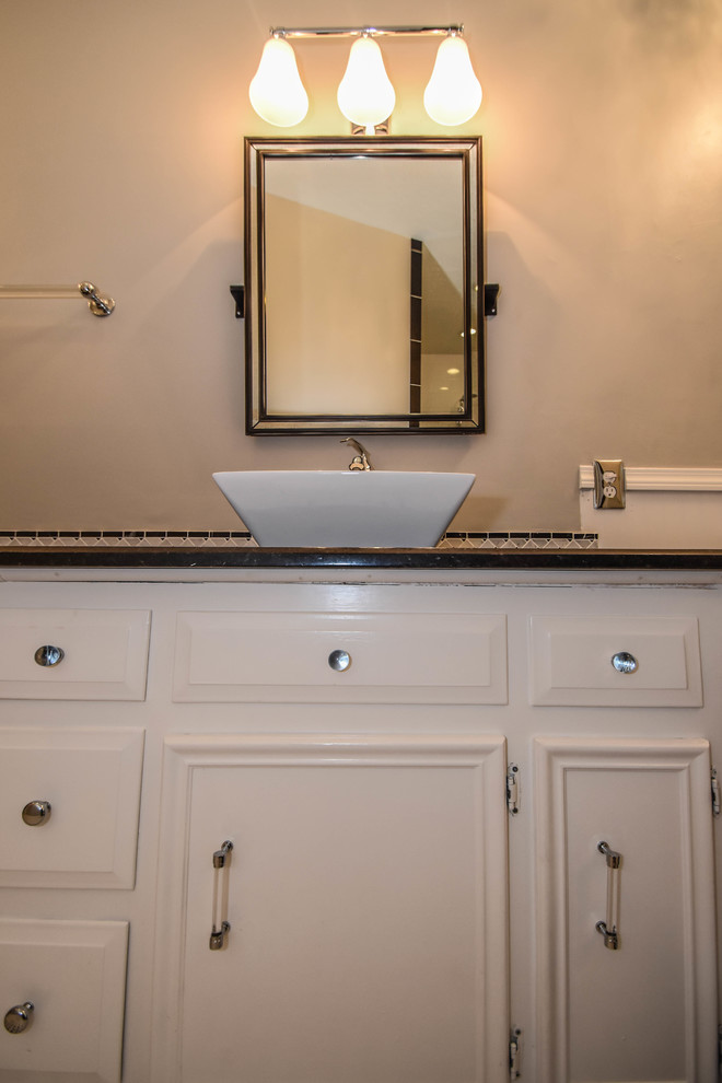 Photo of a transitional master bathroom in Houston with raised-panel cabinets, white cabinets, a claw-foot tub, an open shower, a one-piece toilet, black and white tile, mosaic tile, grey walls, mosaic tile floors, a vessel sink and granite benchtops.