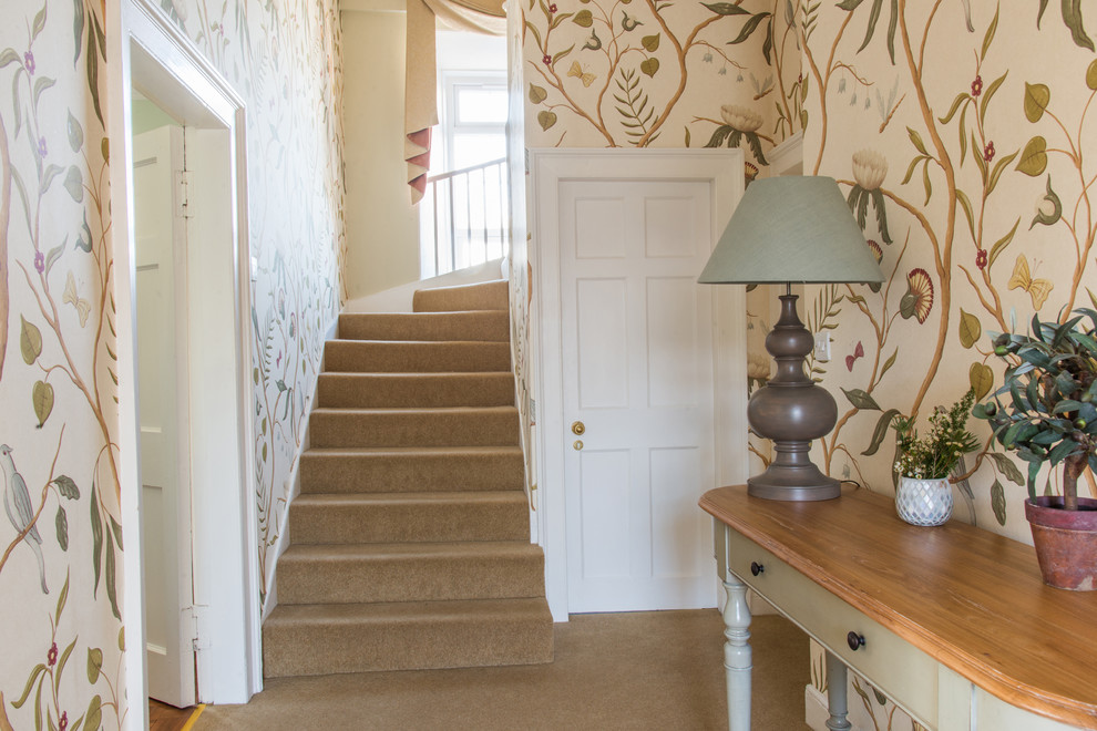 Mid-sized traditional hallway in Edinburgh with multi-coloured walls, carpet and beige floor.